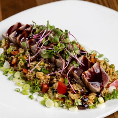Roasted duck breast with mixed quinoa, black barley, farro, tomato, scallions, honey balsamic glaze.