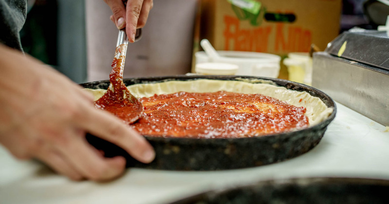 Staff preparing pizza