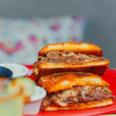 Halved torta sandwich on a red plate.