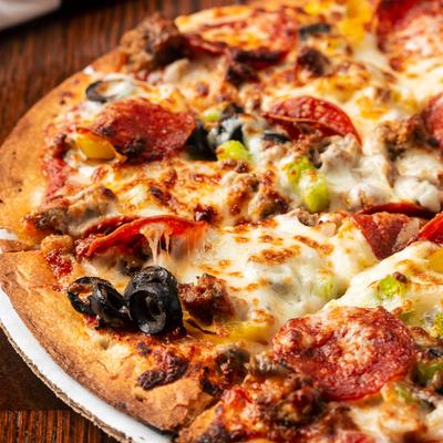 Garbage Pizza, with cheese, pepperoni, black olives, sausage, and peppers.