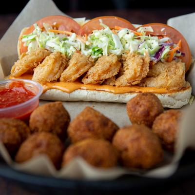 Shrimp Po Boy served with  hush puppies and tomato based sauce