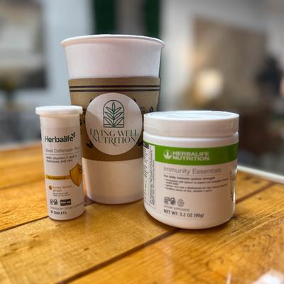 Herbalife Nutrition products placed next to a take away coffee cup.