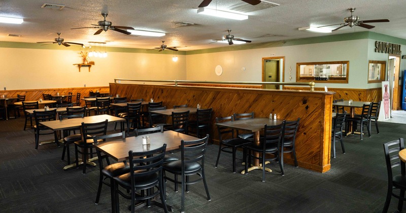 Interior, dining area with wooden tables and black chairs