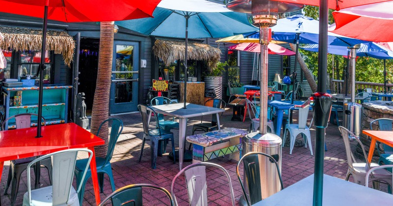 Patio, tables with parasols and seats