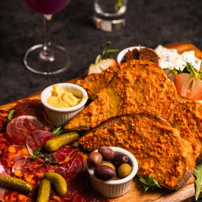 Charcuterie and cheese board with cured meats, artisanal cheeses and condiments.