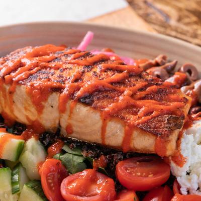 Grilled salmon, with quinoa, goat cheese, and mixed vegetables.