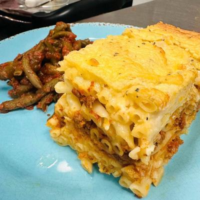 Greek beef pasta bake with a side of stewed green beans.