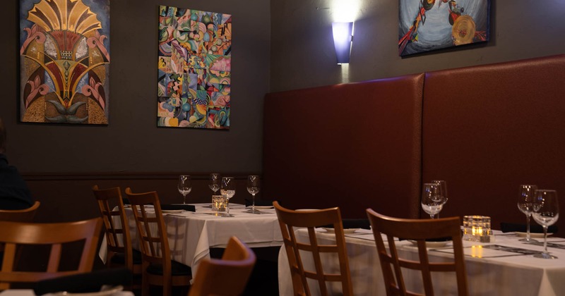 A corner of the dining room with paintings on the walls