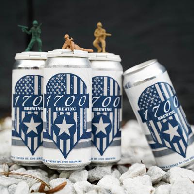 Four cans of 1700 Brewing beer, presented with miniature toy soldiers.
