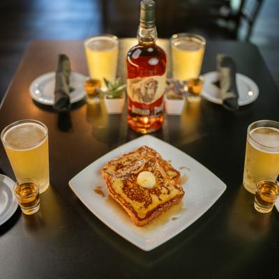French toast topped with whipped butter, served with draft beers and bourbon shots.
