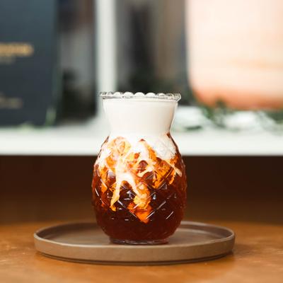 Thai Tea served in pineapple shaped glass.