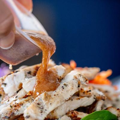 Dressing grilled Chicken with miso honey, close up.