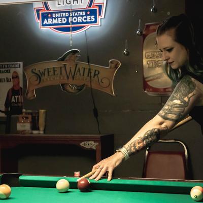 A person playing pool.