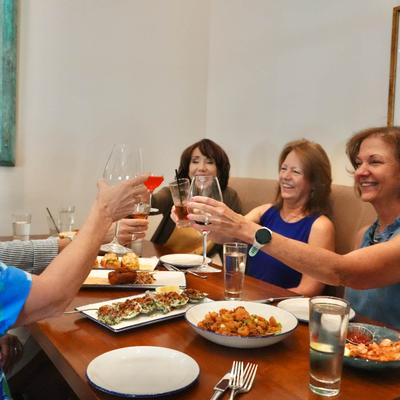 Guests toasting with their drinks.