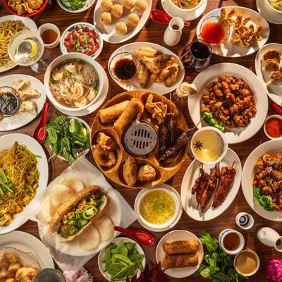 A large spread of assorted dishes on a table, overhead view.