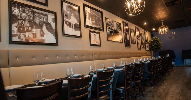 Tables lined up against the wall with photographs