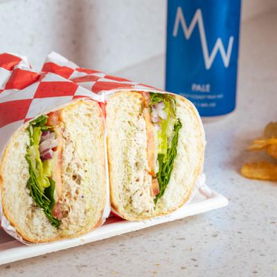 Tuna sandwich cut in half and served.