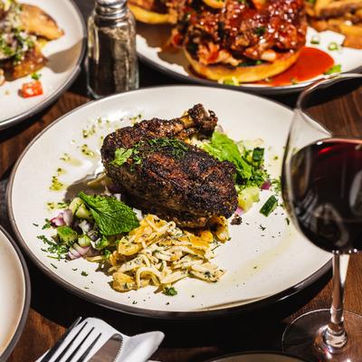 Blackened chicken breast, with noodles and salad.