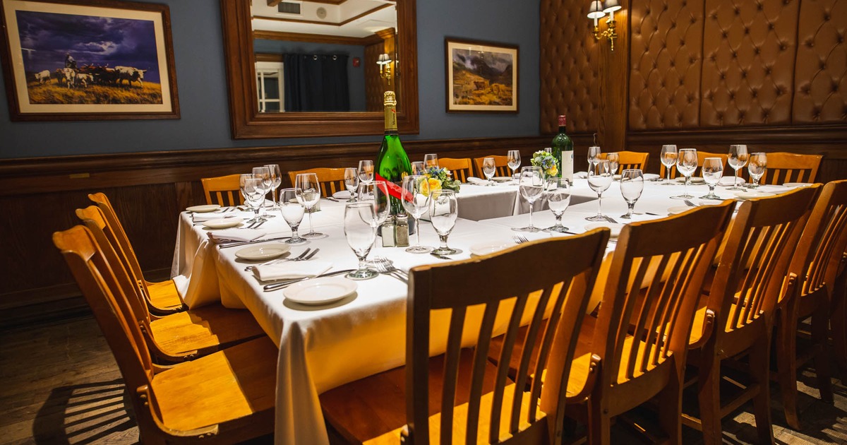 Inside, tables and chairs, tableware and glasses ready for guests