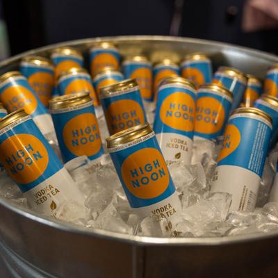 Beer cans in a bucket of ice.