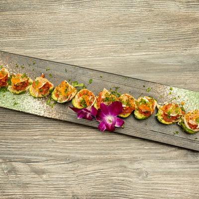 Crab, shrimp tempura and spicy tuna rolls, wrapped in avocado.