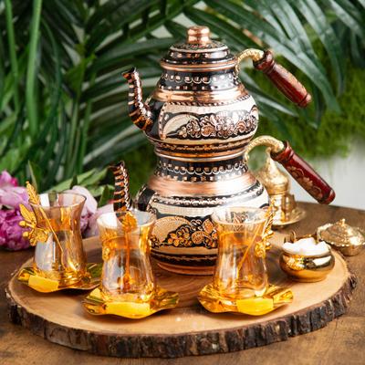 A classic tea pot with glass cups.