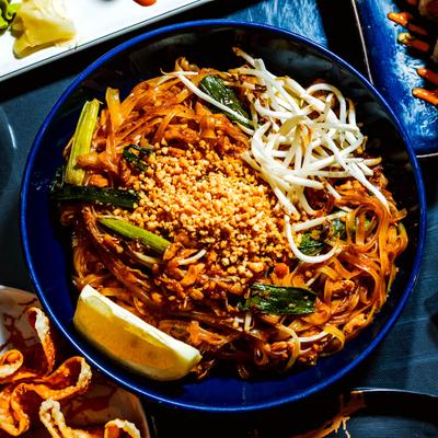 Pad Thai dish topped with fresh sprouts and crushed peanuts.