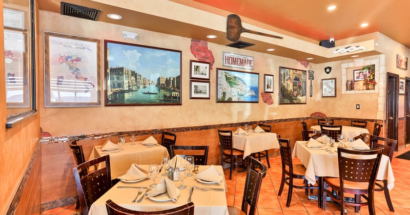 Interior, dining area, tile flooring, various paintings and posters on the wall