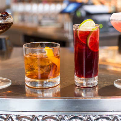 view of four different cocktails displayed on the bar.