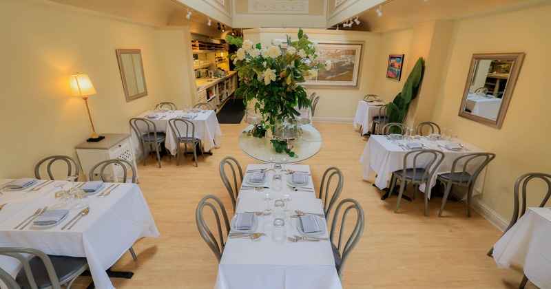 Interior, tables set for guest in dining area