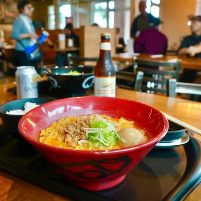 Bowl of Spicy Ramen with minced chicken, green onions and soft boiled egg.