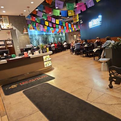 Dining area with tables and colorful papel picado banners.