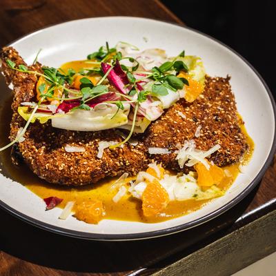 Breaded and fried pork, with mixed vegetables and orange sauce.