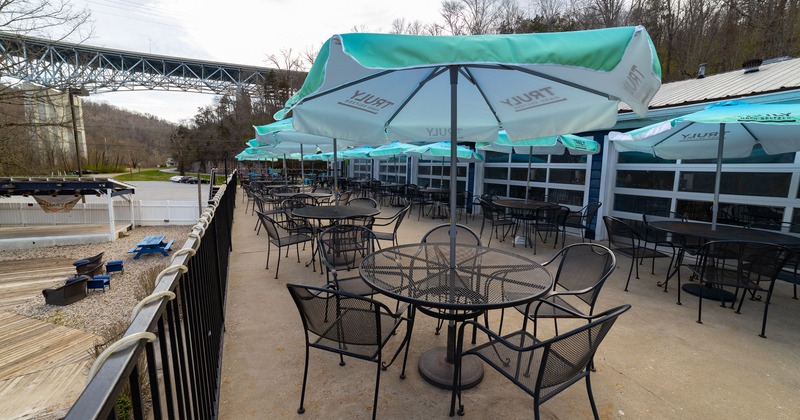 Patio, seating area with tables, chairs and sunshade umbrellas