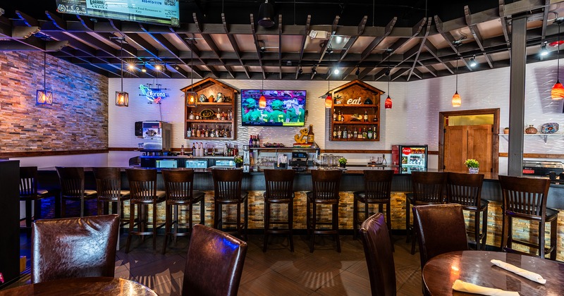 Interior dining area and long bar with wooden stools