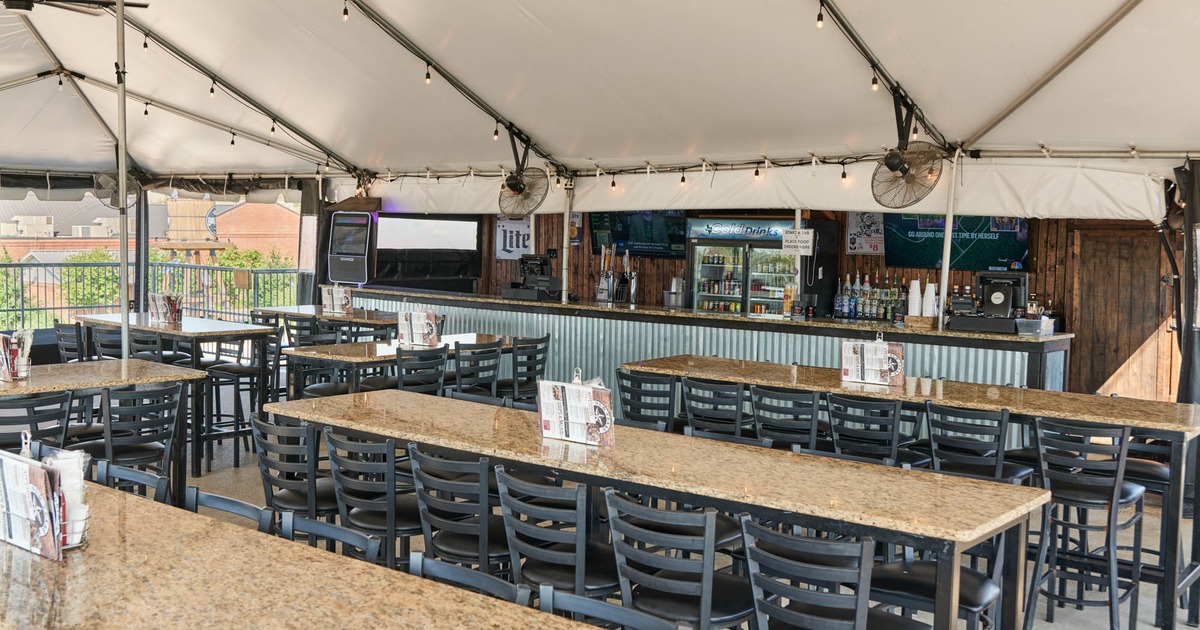 Canopy covered seating area with a bar