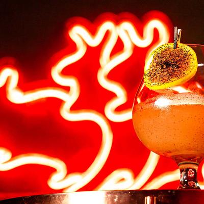 Cocktail next to bar sign