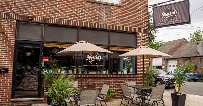Exterior view of Nettie's restaurant with outdoor seating and signage