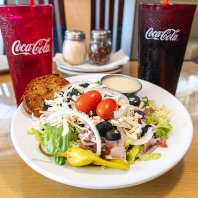 House salad serve alongside two beverages.