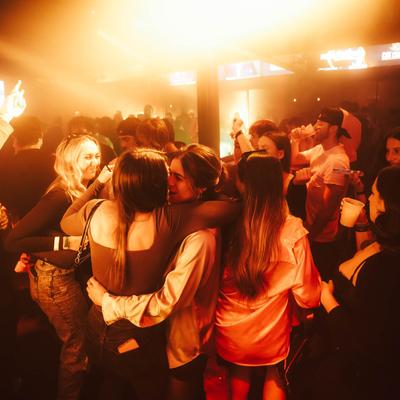 Patrons mingling and drinking.