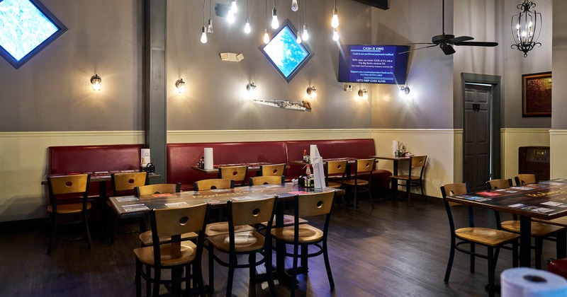 Interior - red booths, wooden tables and chairs and pendant lighting
