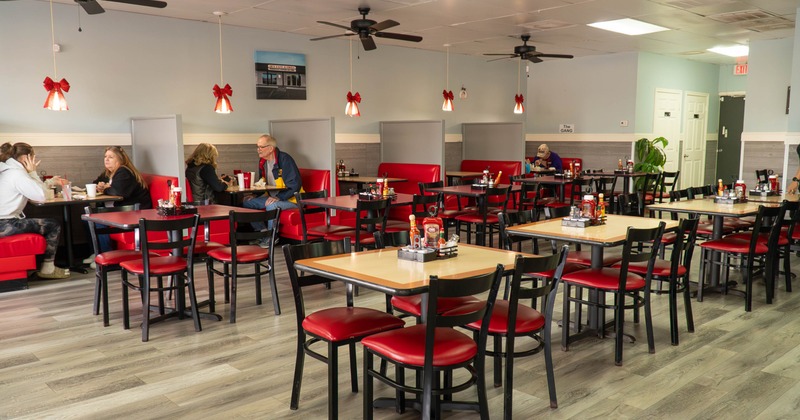 Casual dining restaurant with red booths and chairs