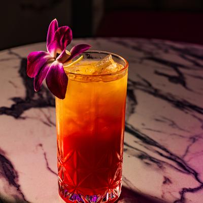 Tequila Sunrise cocktail on a marble table.