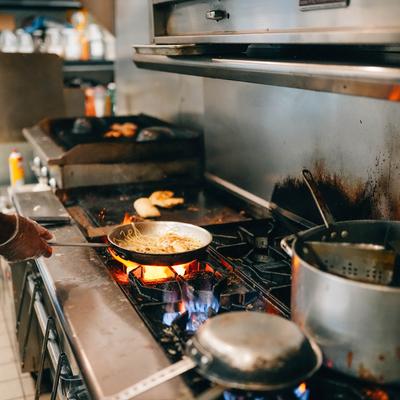 Stir frying noodles in a pan.