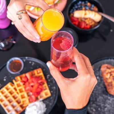 Hands toasting with drinks.