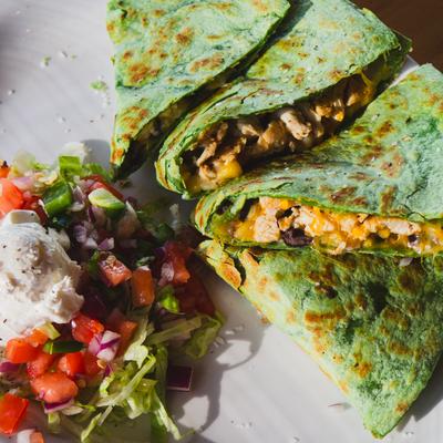 Spinach chicken quesadilla served with pico de gallo.