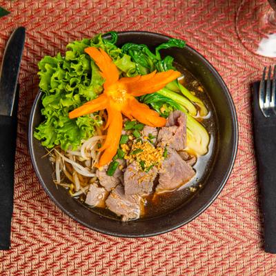 Beef noodle soup with bok choy and bean sprouts.