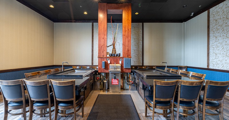 Dining area with grill tables and wooden chairs