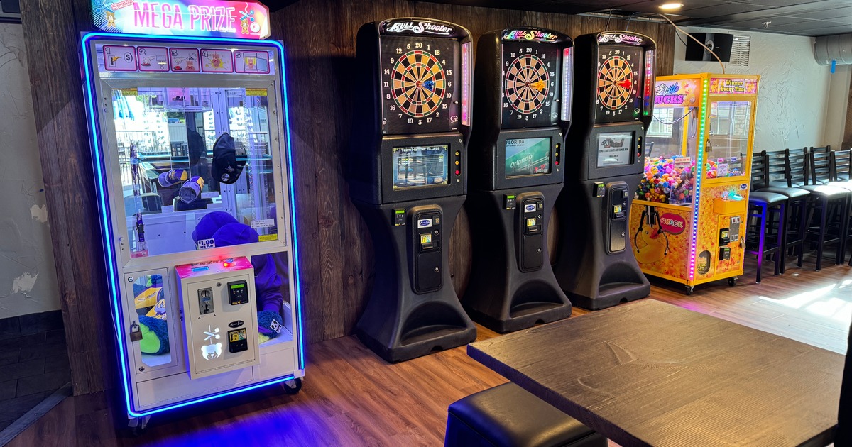 Interior, various games, claw grab, electronic darts, wooden flooring