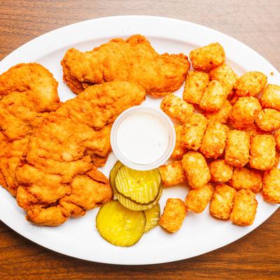 Fried chicken tenders with tater tots, pickles, and dipping sauce.
